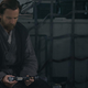 Obi-Wan Kenobi looks at his saber.